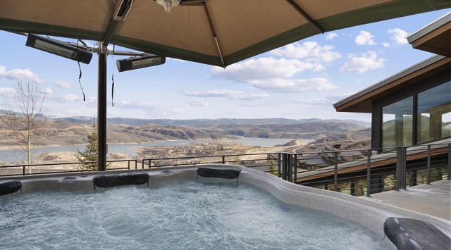 Soak in your private hot tub while gazing across breathtaking rolling hills and distant waters—pure mountain serenity awaits.