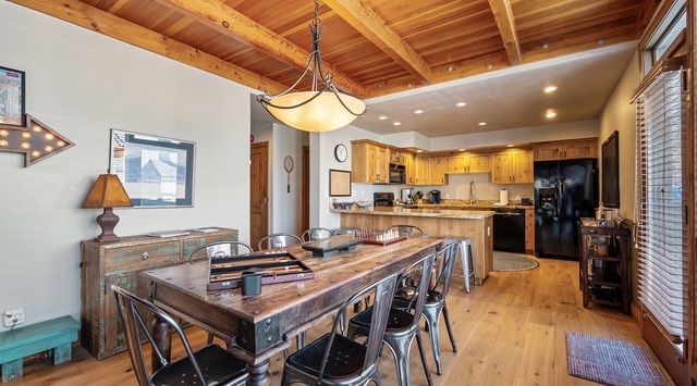 Gather around this stunning wood beam dining space where warm lighting and rustic charm create perfect moments for your group meals together.