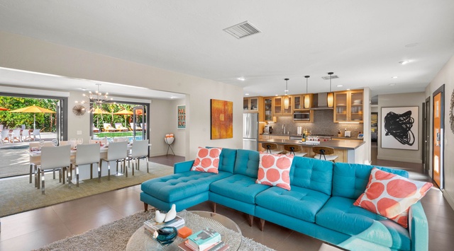 Sink into your vibrant turquoise sectional and enjoy this bright, open living space that flows seamlessly to your private pool oasis.