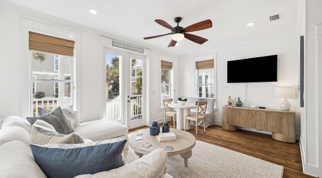 Unwind in your bright coastal living space featuring plush seating and French doors opening to your private balcony.