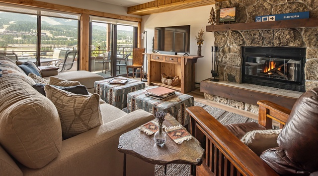 Curl up by the crackling fireplace with mountain views framing your alpine getaway. Rich leather seating and rustic wood touches create your cozy sanctuary after a day exploring the slopes.