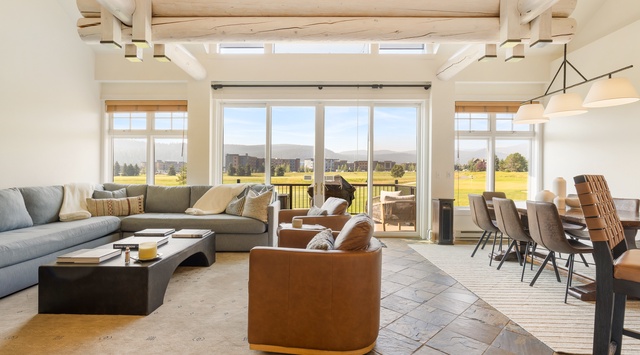 Sunlight pours through soaring windows, illuminating your open-concept living space where modern comfort meets mountain serenity—perfect for gathering with loved ones or simply soaking in those breathtaking views.