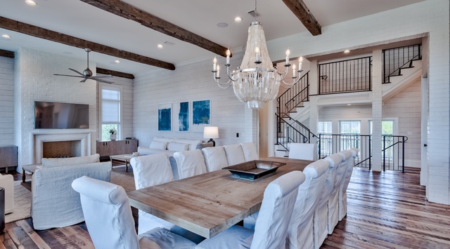 Gather around this elegant dining table while rustic beams and a crystal chandelier create the perfect ambiance for your memorable meals together.