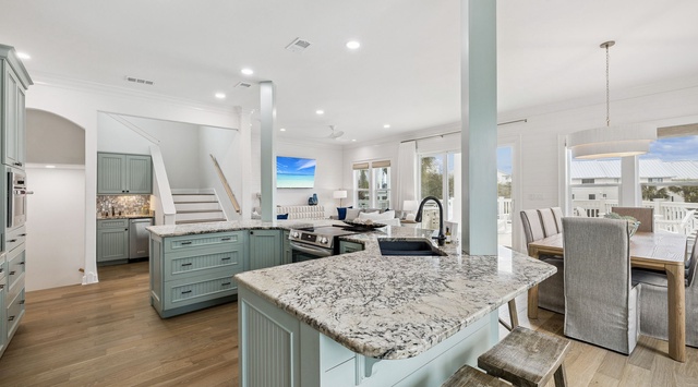 Your spacious open-concept kitchen features granite countertops, coastal-inspired cabinetry, and flows seamlessly into the living area for effortless entertaining.