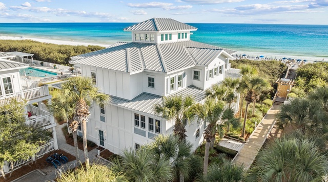 Stunning beachfront property with direct access to pristine turquoise waters and white sand beach. Multi-level coastal architecture surrounded by lush tropical landscaping creates an idyllic vacation retreat.