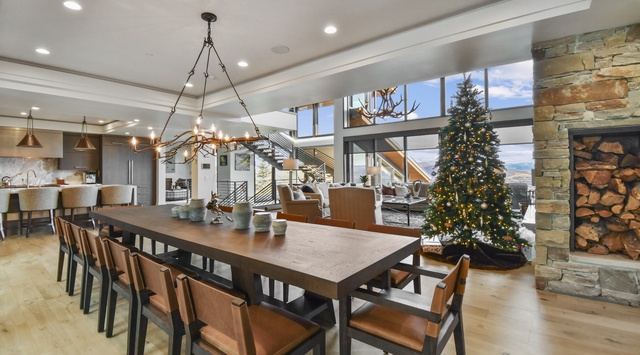 Gather around this stunning dining table where holiday memories unfold, with mountain views and cozy fireplace creating the perfect festive atmosphere.