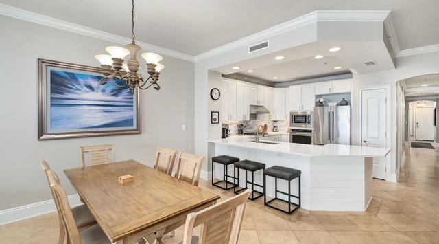 Your open-concept dining and kitchen area invites you to gather around the spacious table or relax at the breakfast bar, with modern appliances and elegant lighting making meal prep and dining feel effortless.