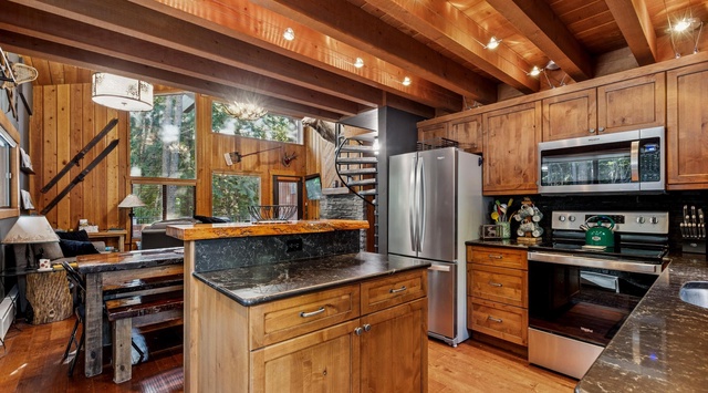You'll love cooking in this stunning rustic kitchen with exposed beams, granite counters, and modern appliances.