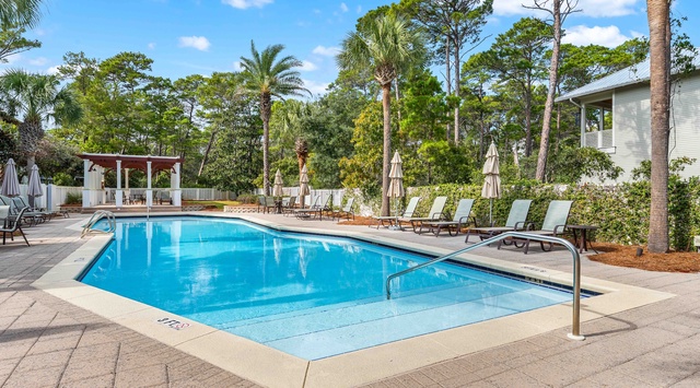 Dive into crystal-clear waters surrounded by tropical palms and comfortable loungers for your perfect poolside retreat.