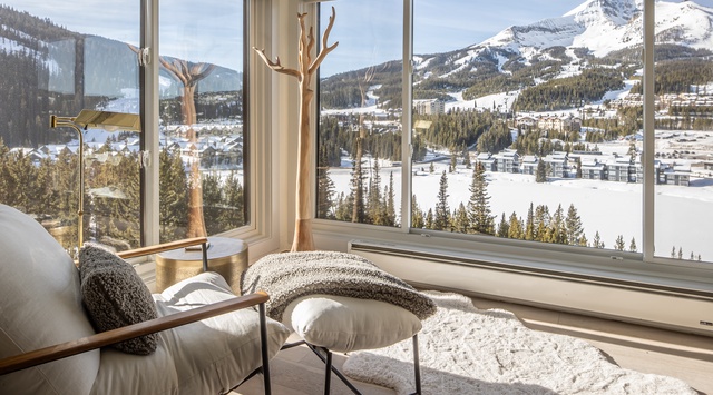 Curl up in your cozy reading nook while soaking in breathtaking mountain vistas through floor-to-ceiling windows.