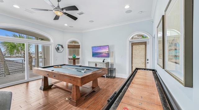 Your private game room features a stunning pool table and shuffleboard, perfect for friendly competition with tropical views.