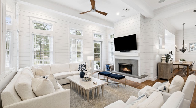 Sink into plush sofas by the fireplace and enjoy your favorite shows on the flat-screen TV in this bright, airy living space designed for relaxation.