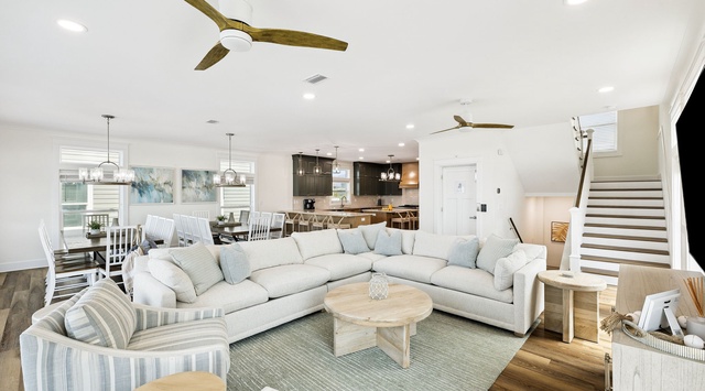You'll love the bright, open flow of this inviting living area, where soft coastal colors, cozy seating, and natural wood tones create your perfect home-away-from-home retreat.