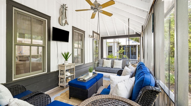 Curl up with your morning coffee on the porch swing, where high ceilings and gentle breezes create your perfect retreat for lazy afternoons.