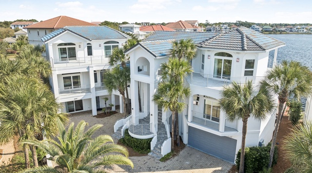 Stunning waterfront estate with panoramic lake views and lush tropical landscaping creates the perfect Florida getaway.