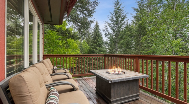 Settle into your private deck, surrounded by towering evergreens and fresh mountain air. The fire table invites you to gather, unwind, and soak in the peaceful forest views.