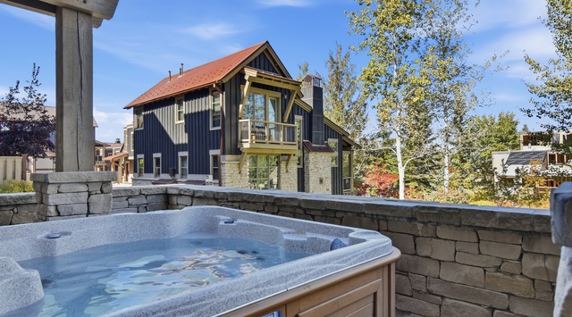 A private hot tub nestled in a stone-walled terrace offers the perfect spot to soak and unwind under the open sky.