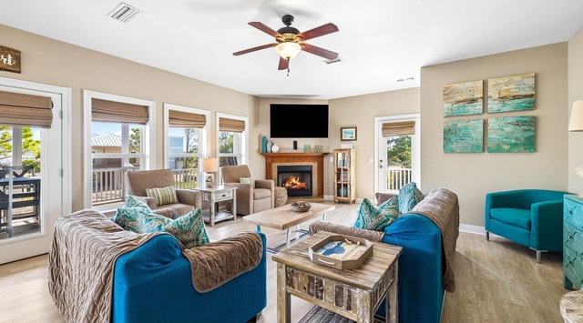 Unwind in your bright living room where coastal-chic style meets comfort. Plush seating surrounds a cozy fireplace, while ocean breezes drift through your private balcony doors—perfect for relaxing after beach days.