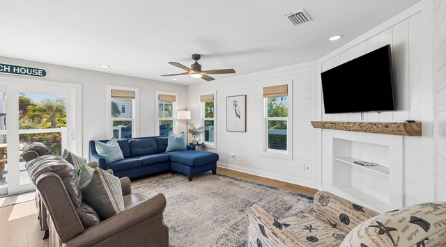 Settle into your bright coastal retreat with plush seating, a cozy fireplace, and a ceiling fan to keep you comfortable year-round. Natural light pours through multiple windows, making this the perfect spot to unwind after a beach day.