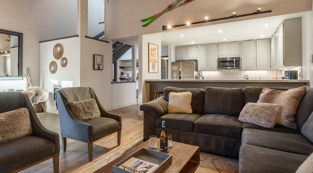 Sink into plush sofas and unwind in your stylish open-concept living space, where warm textures and mountain charm create the perfect après-ski retreat.