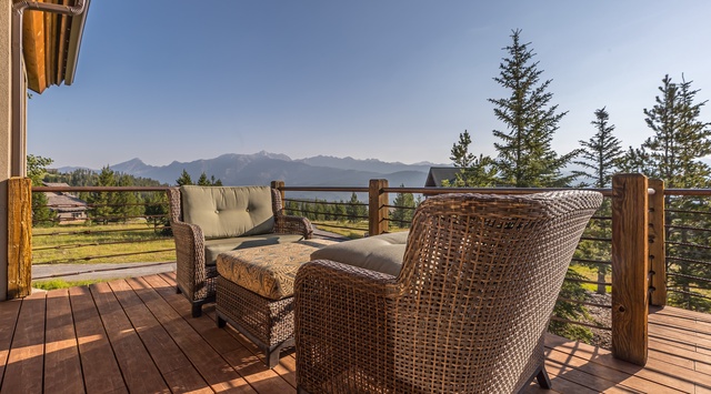 Settle into comfort on your private deck, where majestic mountain views stretch across the horizon and peaceful alpine meadows frame your retreat beneath open skies.