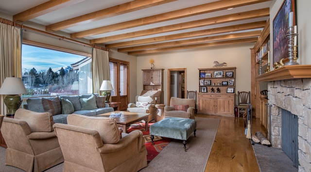 Sink into plush seating by your crackling fireplace while mountain views frame your perfect evening retreat.