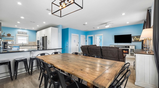 Gather around the spacious dining table for meals and memories in your bright, open-concept living space. The fully equipped kitchen and cozy lounge area make this the heart of your vacation home.