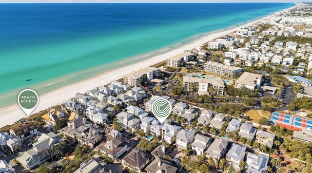 Stunning aerial perspective showcasing beachfront community with pristine white sand beaches and crystal-clear turquoise waters.