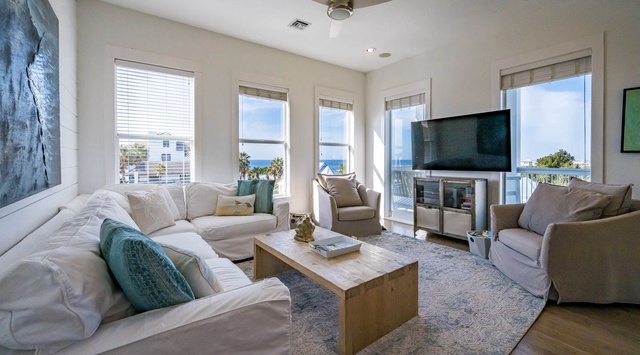 Sink into plush sofas while ocean breezes flow through your bright living space, where sea views frame every moment of relaxation.