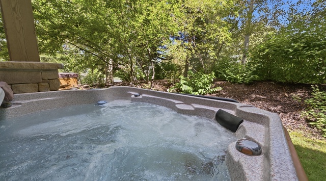 Sink into the bubbling warmth of your private hot tub, surrounded by lush greenery and open sky. It's the perfect spot to unwind after a day of adventure.