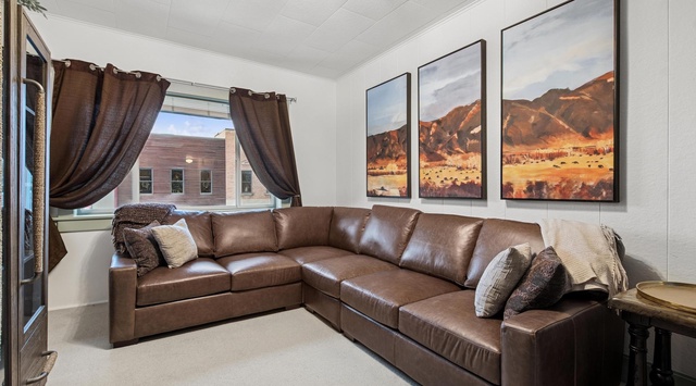 Sink into this luxurious leather sectional while beautiful desert landscape art sets a serene mood for your perfect getaway.