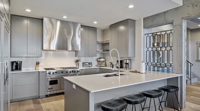 Your gourmet kitchen awaits with sleek granite counters, professional appliances, and stylish bar seating for morning coffee or casual meals.