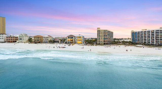 Pristine white sand beach meets crystal-clear turquoise waters in this stunning coastal destination with beachfront accommodations.