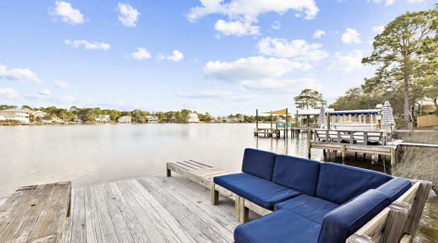 Serene waterfront setting with comfortable seating overlooking calm waters and charming coastal homes.