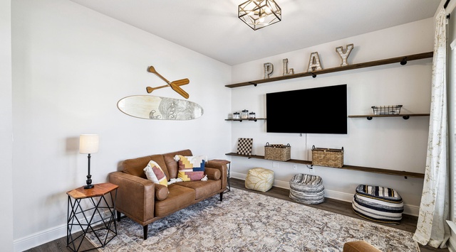 Your cozy game room awaits with comfortable seating and entertainment setup for relaxing evenings.