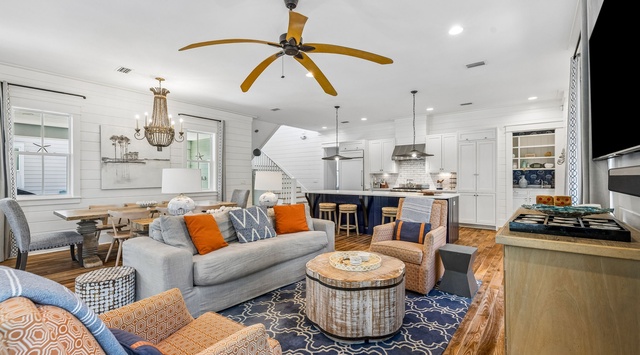 Settle into your open-concept living space where coastal style meets homey comfort—plush seating, warm wood tones, and natural light create the perfect gathering spot for your crew.