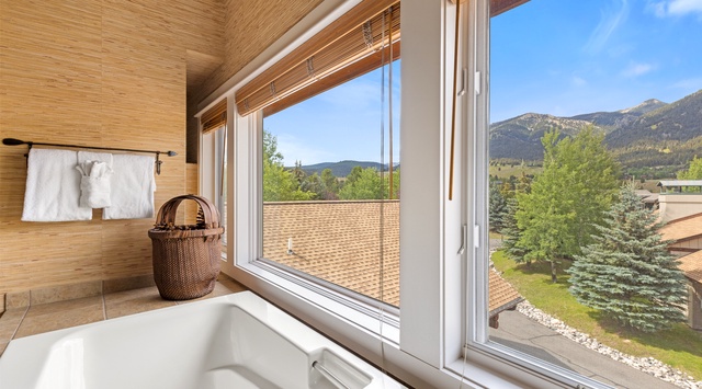 Soak in the tub while taking in panoramic mountain views framed by your private window—pure relaxation with nature as your backdrop.