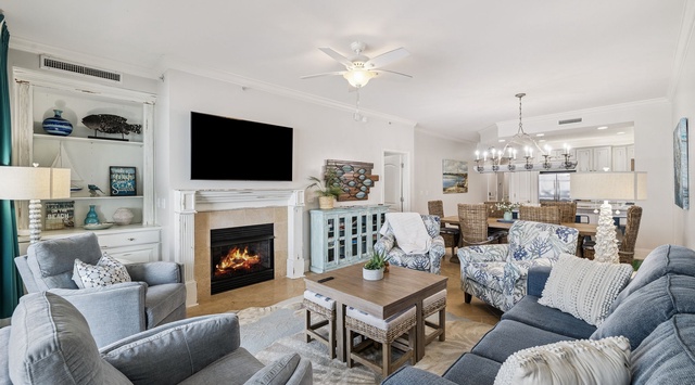 Sink into plush coastal-style seating around the crackling fireplace, with your favorite shows on the big screen and open kitchen perfect for gathering.