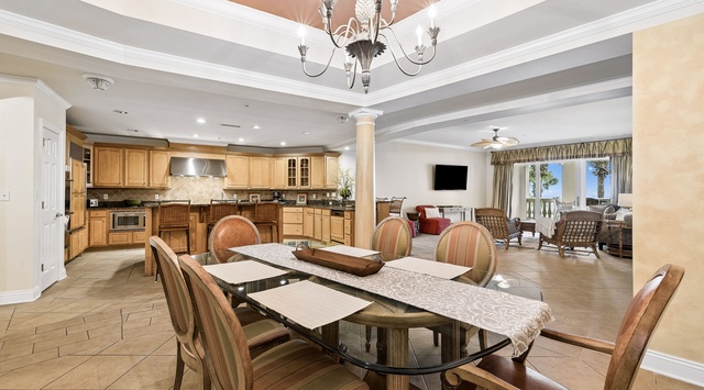 A spacious open layout where your gourmet kitchen flows into your elegant dining and living areas, perfect for gathering with loved ones under a stunning chandelier.