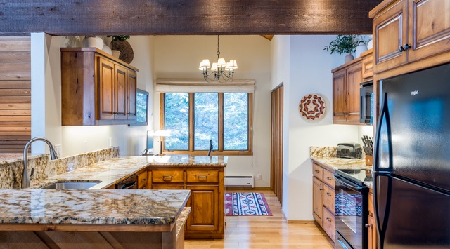 Your gourmet kitchen features granite countertops, stainless steel appliances, and rustic wood cabinets—perfect for creating memorable meals together.