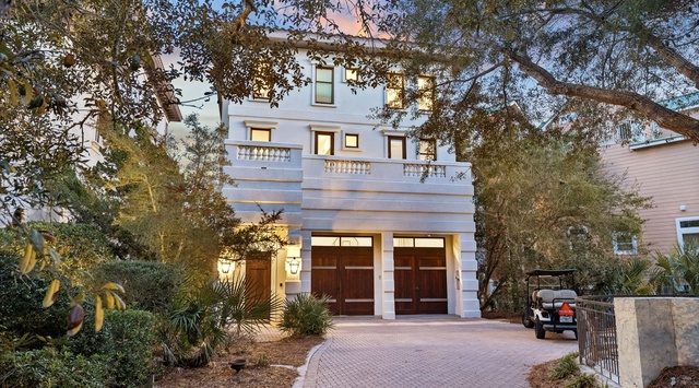 Elegant property facade with sophisticated architectural details and mature landscaping in an upscale residential setting.
