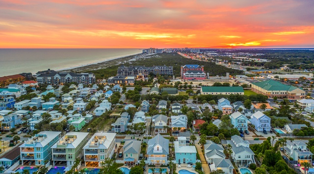 Spectacular sunset view over the coastal vacation rental community with beachside homes and resort-style amenities nearby.