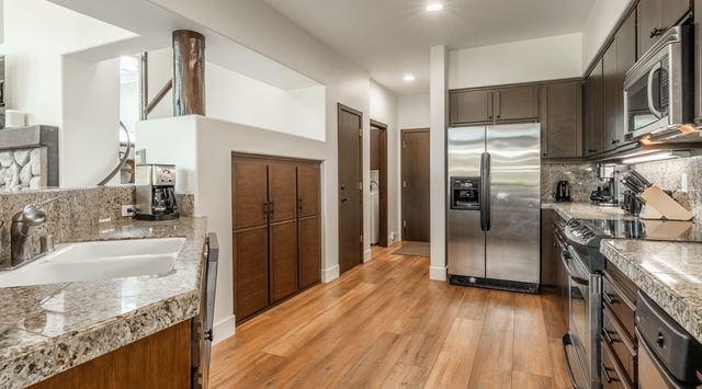 Your fully equipped kitchen features granite countertops, stainless steel appliances, and warm hardwood floors. The spacious layout and modern finishes make meal prep a pleasure.
