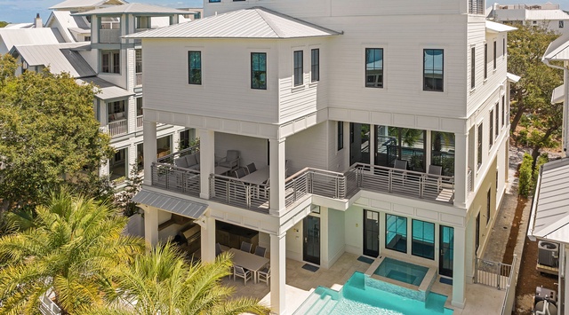 A modern coastal retreat offering spacious multi-level living, private pool, and rooftop terrace amid lush landscaping in a serene beachside neighborhood.