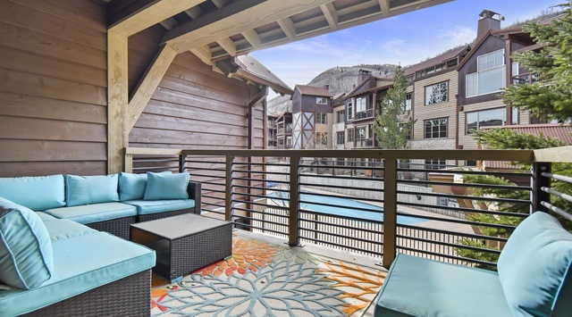 Unwind on your private balcony with plush seating and mountain village views, perfect for morning coffee or evening relaxation.