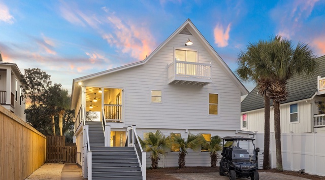 Modern coastal beach house with elegant architecture and tropical landscaping in a peaceful residential setting.