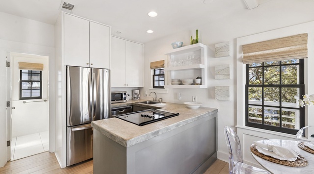 Your sleek kitchen features modern appliances and bright island for easy meal preparation.