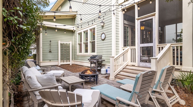 Unwind in your private courtyard oasis with cozy seating, fire pit, and twinkling lights creating the perfect evening ambiance.