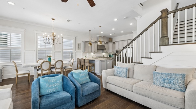 Unwind in your open-concept living space with vaulted ceilings, elegant furnishings, and a fully equipped kitchen ready for your coastal getaway.