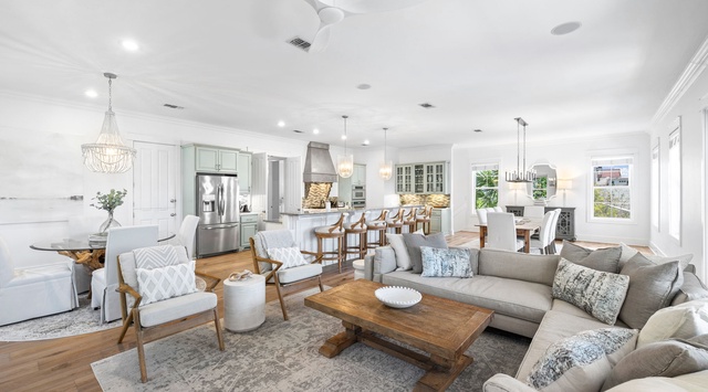 Settle into your elegant open-concept living space where coastal charm meets modern comfort, perfect for gathering with loved ones.